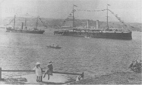 HMS Royal Arthur, Flagship of the Australia Station (Rear Admiral Beaumont RN) anchored in Farm Cove, Sydney, and dressed overall to celebrate the birth of Australian Federation on New Year's Day, 1901) Adjacent vessel is HMS Torch (sloop).