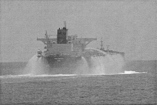 The 115,000 dead weight tonne tanker MV Dubai Princess spraying water in an attempt to prevent pirates boarding. (Image:RAN)