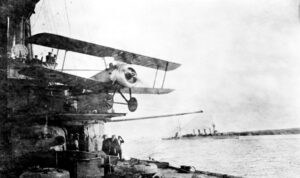 Sopwith Pup from HMAS Sydney with HMAS Melbourne in the background