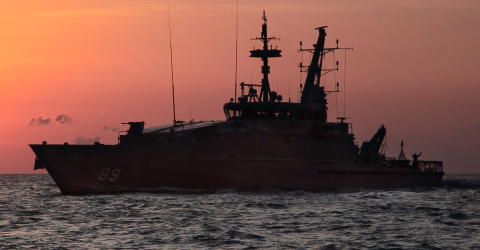 HMAS Ararat sails at sunset off the coast of Darwin, Northern Territory.