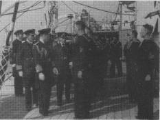 On arrival at Portsmouth the Prince of Wales and the Duke of York came aboard to greet their younger brother. The Princes are seen here inspecting part of the ship's company at "Divisions". 28.3.35