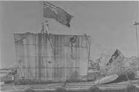 Members Lieutenant Commander Peter Churchill and Mr Lew Lind raise the flag as the bow and stern sections of HMAS Parramatta enter Sydney harbour.