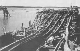 The twisted remains of the main wharf at Darwin after the Japanese air raid on 19 February, 1942.