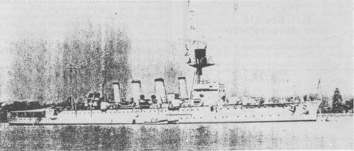 HMAS ADELAIDE, mid 1920s. Two 6-inch guns are sited forward of the bridge, one on each beam; two searchlights amidships and abaft the fourth funnel; a wireless cabin is sited between the fore and second funnels and the control top and director tower are painted black.