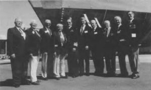 The keel laying of the third Huon Class Coastal Memorial Minehunter HMAS NORMAN, 16 September. Members of the `N' Class Destroyer Association. (HMAS `HUON) in the background. Left to Right: Eric Young (Norman), Alan Gill (Norman), George Magee (Norman), Stan McAndrew (Napier) VADM Rod Taylor, C.N.S., Mr. Ken Harris G.M., ADI, Bruce Loxton (Norman), Bert Westaway (Norman), Bill Cook (Nizam), Len Delaney (Nepal).