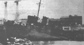 HMS Campbelltown wedged fast in the dock gates after her valiant attack.