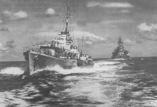 The photograph shows the "N" class destroyer Nepal coming up astern of the battleship "Queen Elizabeth" to receive a package from Admiral Somerville. Astern is the battleship "Valiant". The officer standing in the destroyer's bow is Leut. Brian Murray (later Rear Admiral Sir Brian Murray). The writer of this article is on the flag deck.
