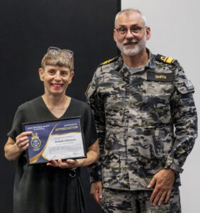 Commander Australian Fleet, Rear Admiral Christopher Smith, AM, CSM, RAN presents Ms Belinda Johnstone with a certificate of appreciation on completion of the Naval Historical Society website launch held at the Castlereagh Boutique Hotel, Sydney.