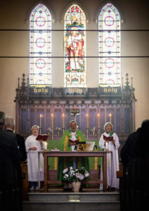 Royal Australian Navy Chaplain Catherine Wynn-Jones (right) participates in prayer with members of St John's church, Birchgrove, New South Wales.