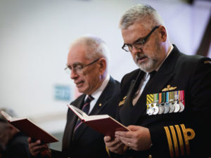 Commanding Officer of HMAS Kuttabul Captain Viktor Pilicic, CSC, RAN (right) and Vice President of the Naval Historical Society Mr John Jeremy, AM, recite a prayer at St John's church during the Australian White Ensign replacement ceremony, Birchgrove, New South Wales.