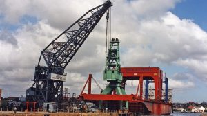The 30-tonne portal crane being loaded on to a heavy-lift ship for transport to Western Australia